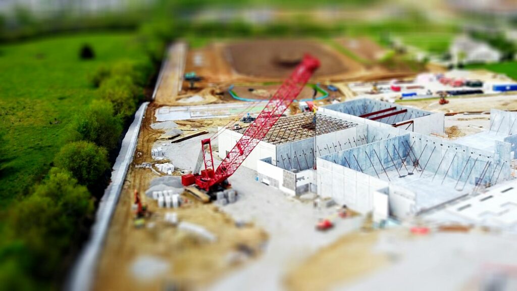 tilt shift lens photography of red crane miniature