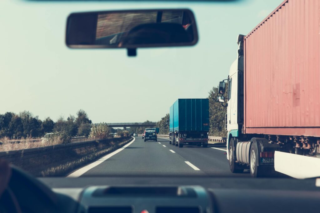 blue and red freight truck on road